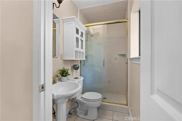 a white toilet sitting next to a bathroom sink