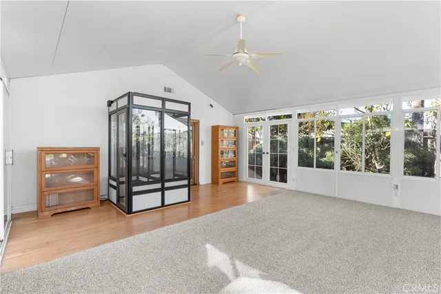 a view of a big room with windows and entryway chandelier