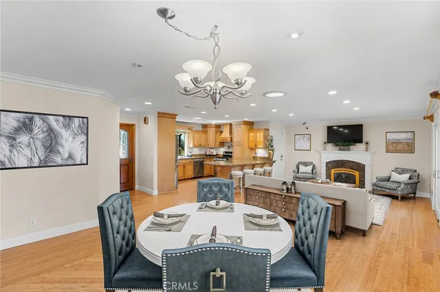 a view of a dining room with furniture wooden floor and chandelier