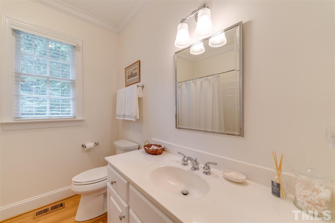 5233 Wildmarsh Drive Raleigh, NC 27613 - Photo 14 of 25 a bathroom with a sink a toilet and mirror