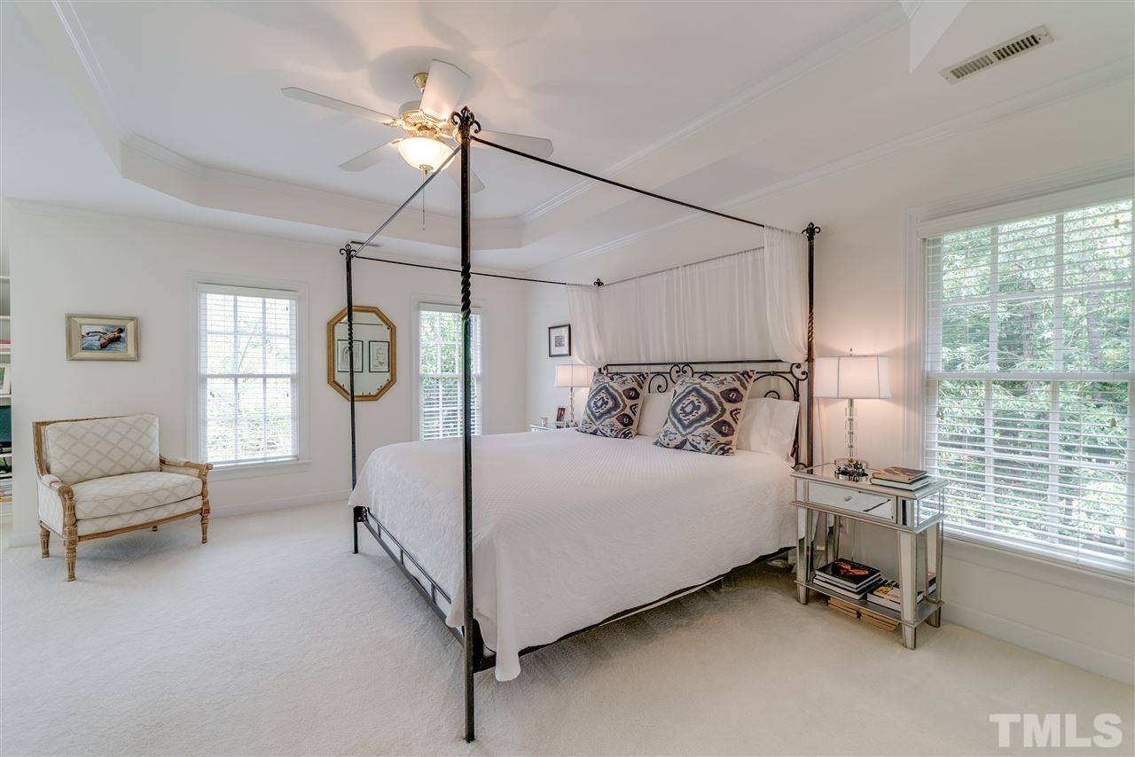 5233 Wildmarsh Drive Raleigh, NC 27613 - Photo 15 of 25 a bed room with a bed and a chandelier