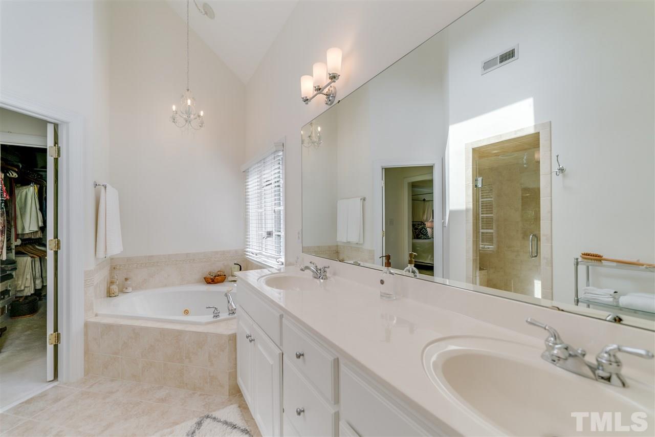 5233 Wildmarsh Drive Raleigh, NC 27613 - Photo 17 of 25 a bathroom with a tub a sink and mirror