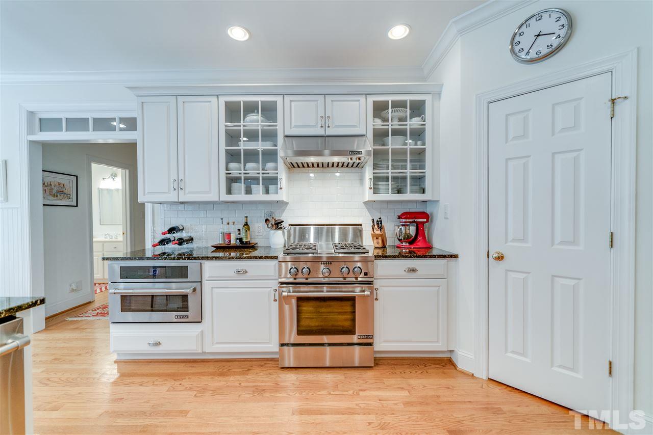 5233 Wildmarsh Drive Raleigh, NC 27613 - Photo 7 of 25 a kitchen with stainless steel appliances granite countertop a stove and cabinets