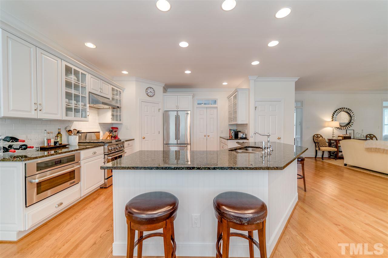 5233 Wildmarsh Drive Raleigh, NC 27613 - Photo 8 of 25 a kitchen with stainless steel appliances granite countertop a stove a sink and a refrigerator