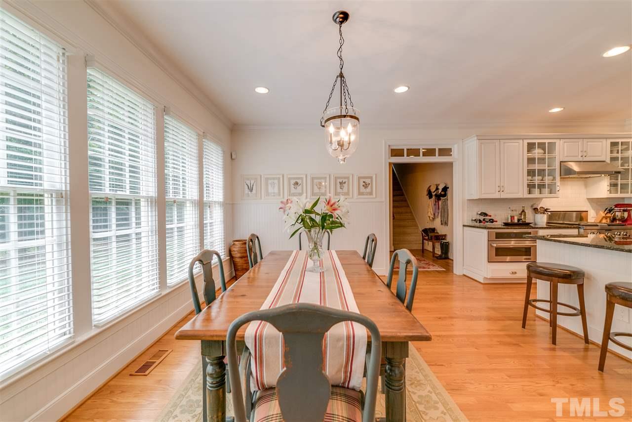 5233 Wildmarsh Drive Raleigh, NC 27613 - Photo 9 of 25 a view of a dining room with furniture window and wooden floor