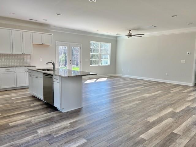 5322 Pond Bluff Drive Monroe, NC 28112 - Photo 3 of 21 a kitchen with granite countertop wooden floors and white cabinets