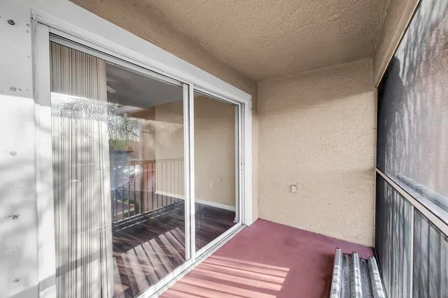 a bedroom with a bed and a glass door shower