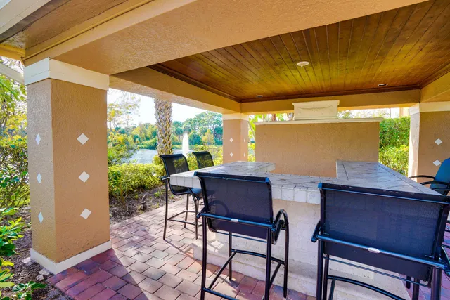 a view of a porch with furniture and a yard