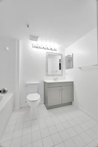 a bathroom with a sink a toilet and mirror