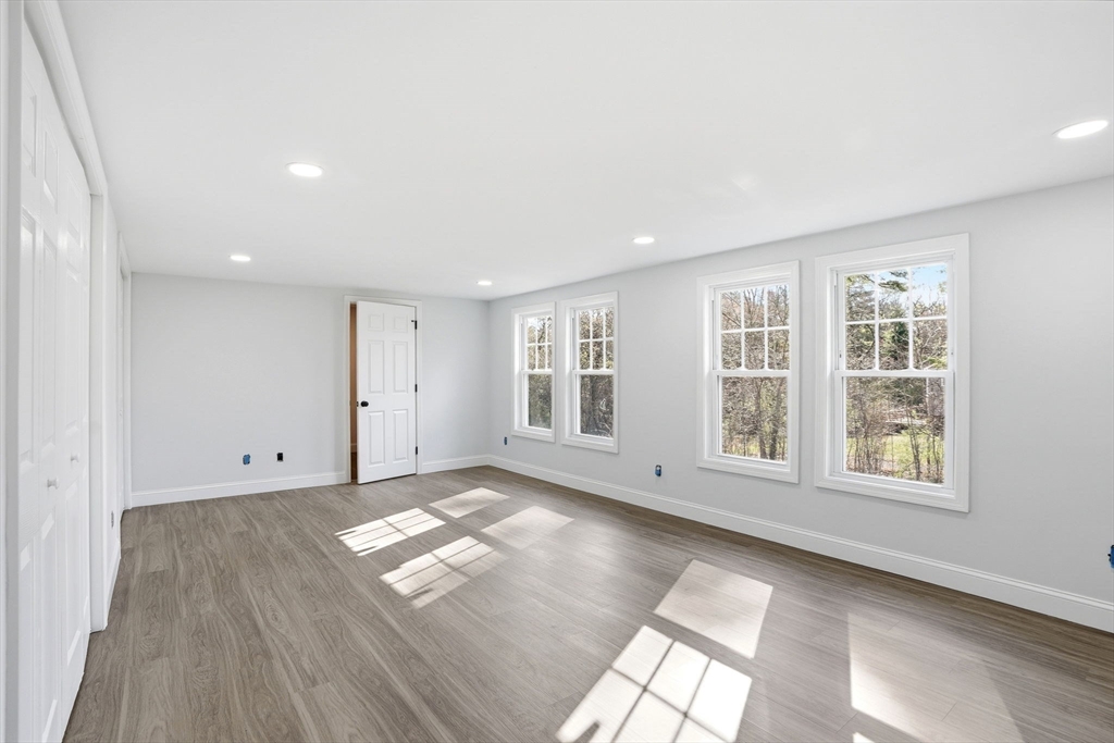 357 Wareham Street Middleboro, MA 02346 - Photo 28 of 42 an empty room with wooden floor and windows