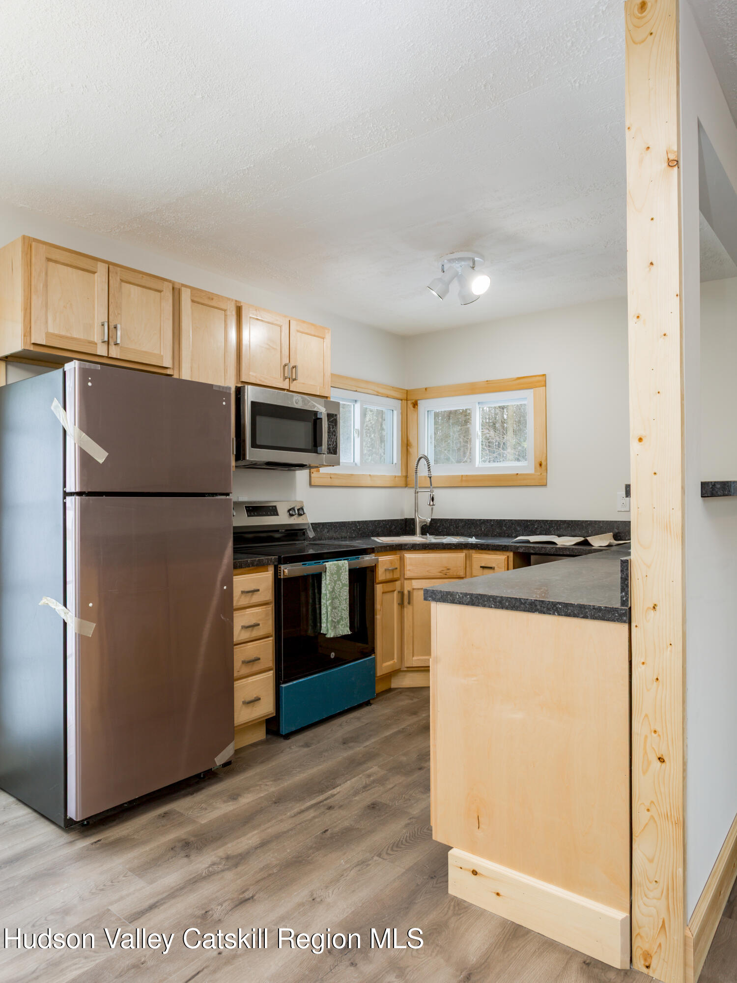 4030 Vega Mountain Road Roxbury, NY 12474 - Photo 14 of 29 a kitchen with stainless steel appliances granite countertop a refrigerator a stove a sink and a refrigerator