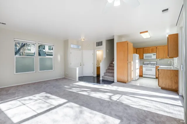 a view of a kitchen with a sink and a refrigerator
