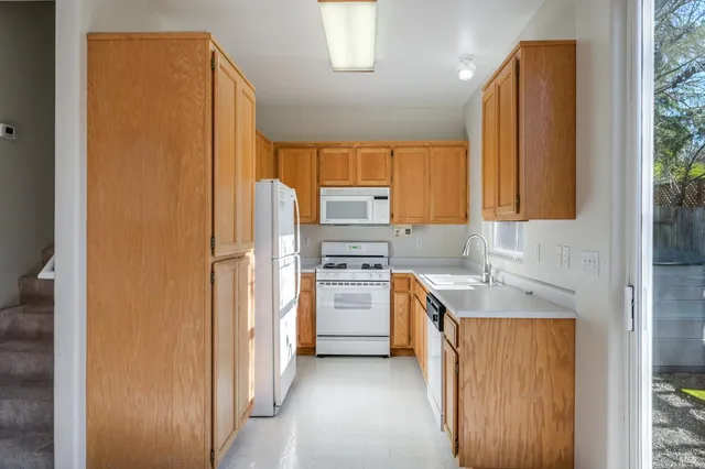 a kitchen with a refrigerator sink and stove