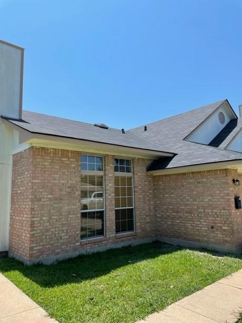 12403 Turtle Rock Road, Unit A Austin, TX 78729 - Photo 2 of 14 A classic brick exterior with well-maintained landscaping and a durable shingle roof.