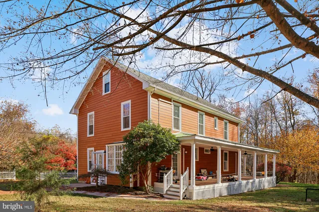 a view of a house with a yard and a tree