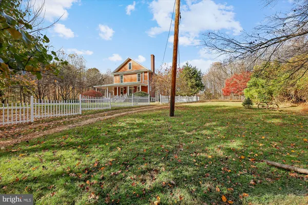 a view of a field with wooden fence