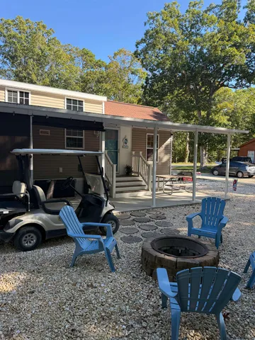 a view of a backyard with sitting area and furniture