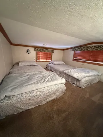 a bedroom with a bed and a night stand