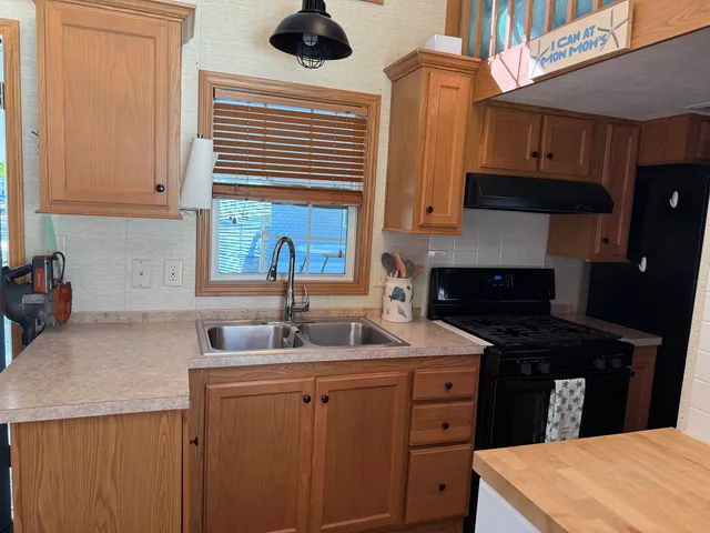 a kitchen with a sink cabinets and a stove