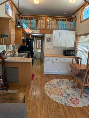 a kitchen with granite countertop a sink stove and cabinets