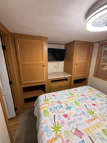 a bedroom with a bed and a window