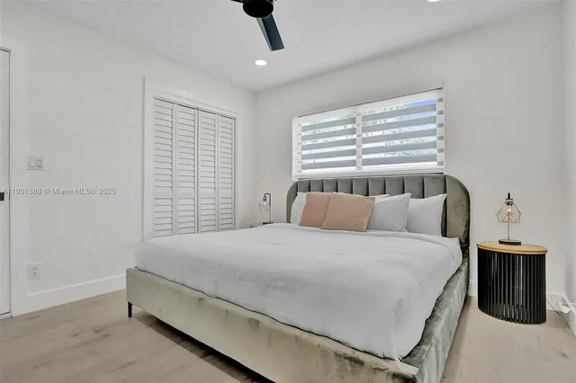 a large bed sitting in a bedroom next to a bathroom