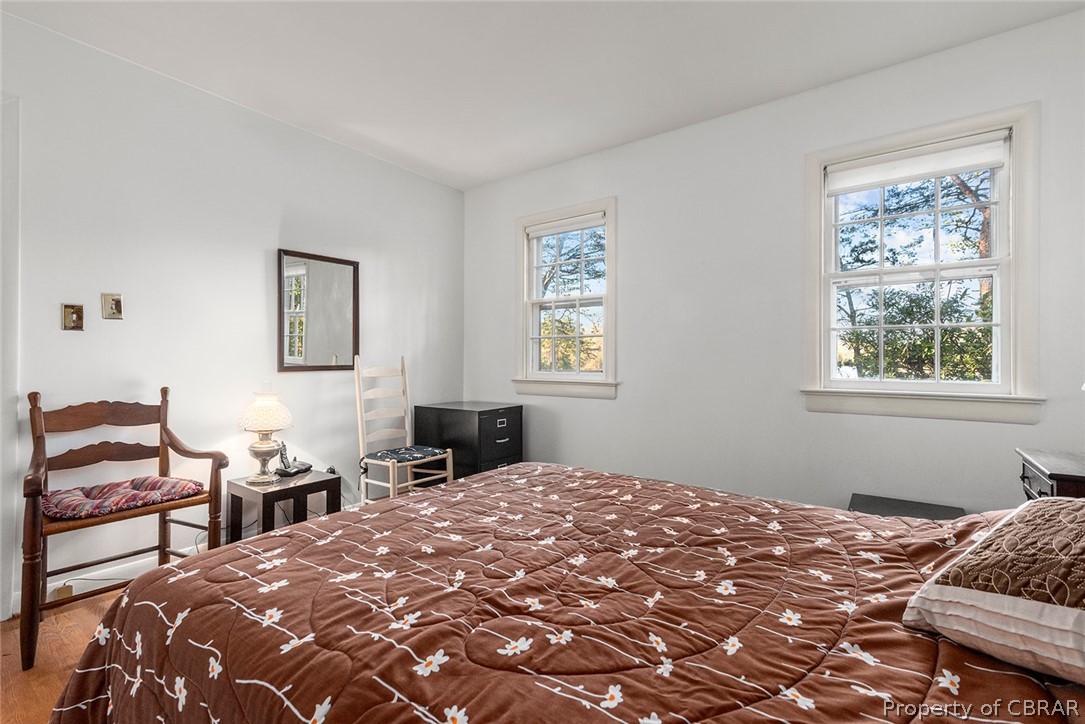 541 Cove Colony Road Lancaster, VA 22503 - Photo 23 of 38 a bedroom with a bed and wooden floor