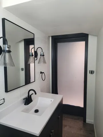 a bathroom with a sink and a mirror
