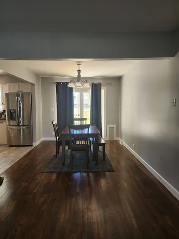a view of dining room with furniture and wooden floor