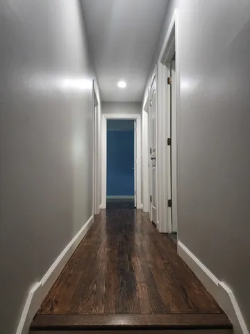 a view of hallway with wooden floor