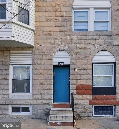 a front view of a house with a door and a yard