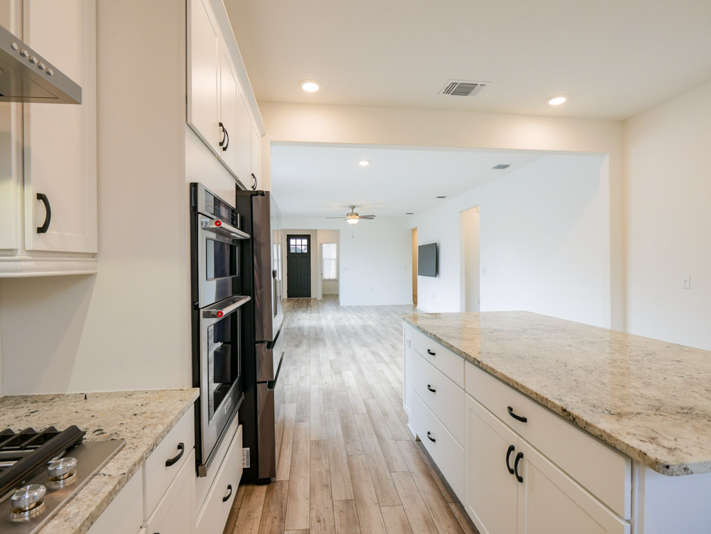 103 Kitty Hawk Road Georgetown, TX 78633 - Photo 15 of 34 a view of a kitchen island wooden floor and stainless steel appliances