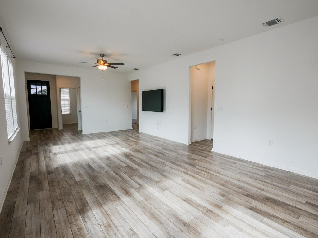 103 Kitty Hawk Road Georgetown, TX 78633 - Photo 9 of 34 wooden floor in an empty room with a window