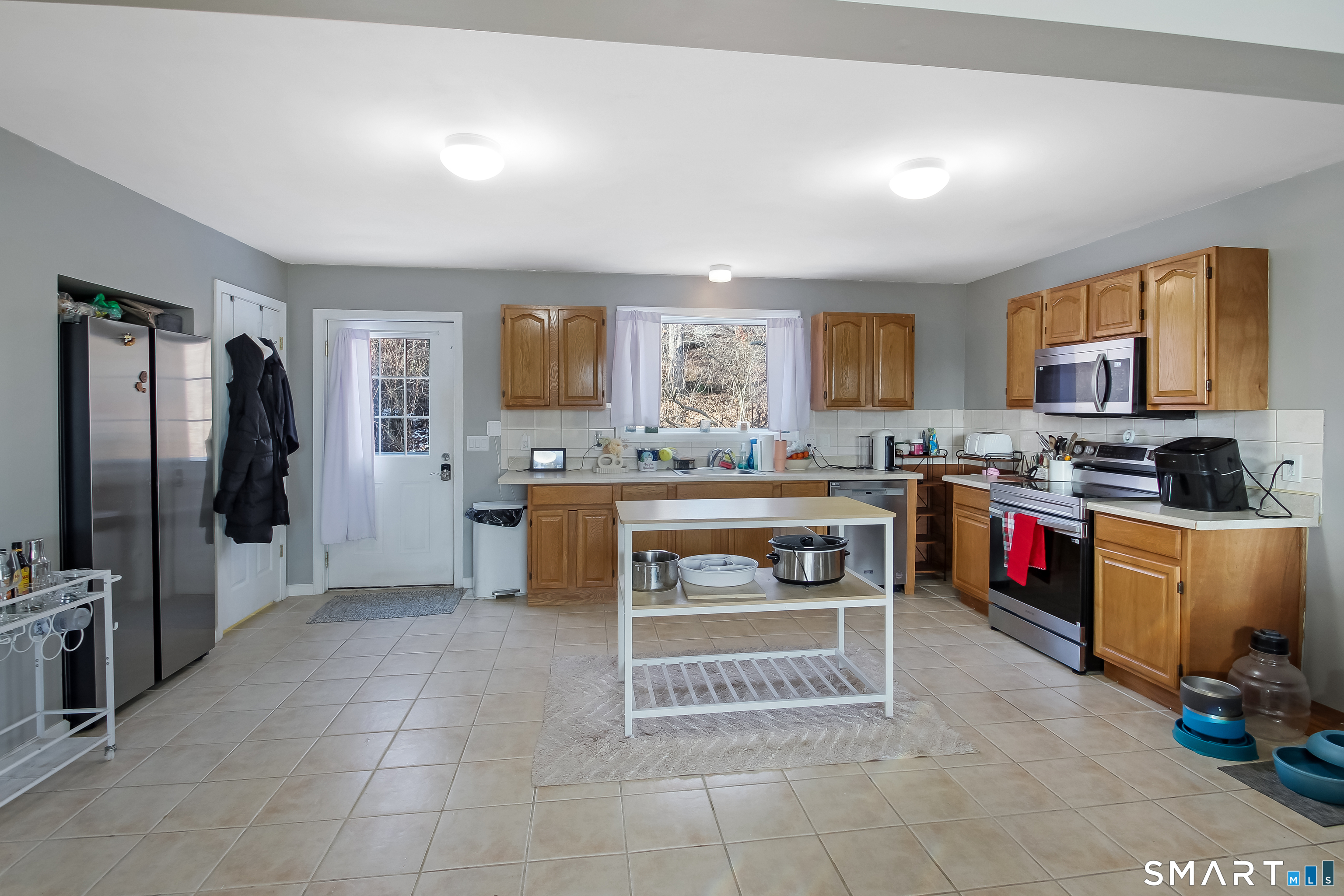 91 Insalaco Drive Windham, CT 06280 - Photo 3 of 20 a kitchen with stainless steel appliances kitchen island granite countertop a stove a sink and a refrigerator