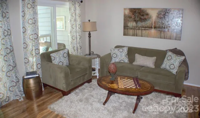 a living room with furniture and a wooden floor
