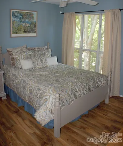 a large bed sitting in a bedroom next to a window