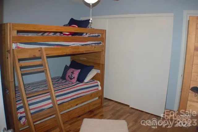 a bedroom with a bunk bed and a dresser