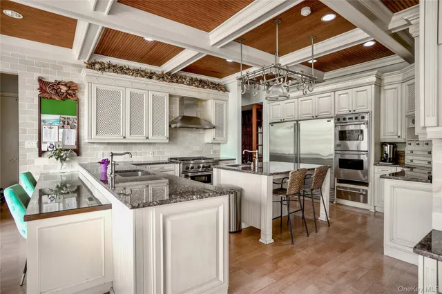 a kitchen with stainless steel appliances granite countertop a sink a counter space and a window