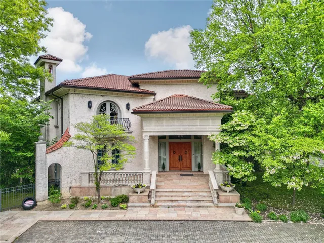 a front view of a house with plants