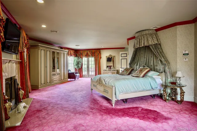 a spacious bedroom with a large bed and a large window