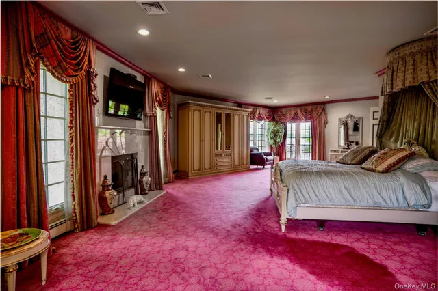 a large tub sitting in a room next to a large window