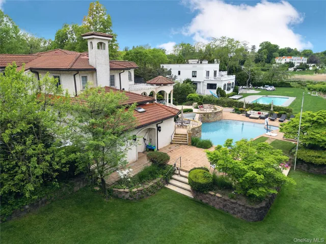an aerial view of a house with garden space and street view