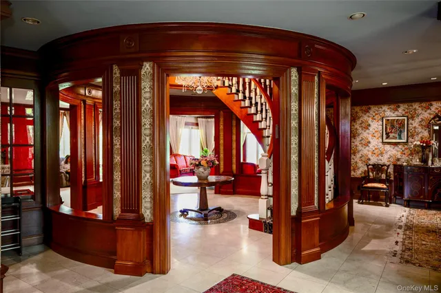 a living room with furniture a rug and a large window