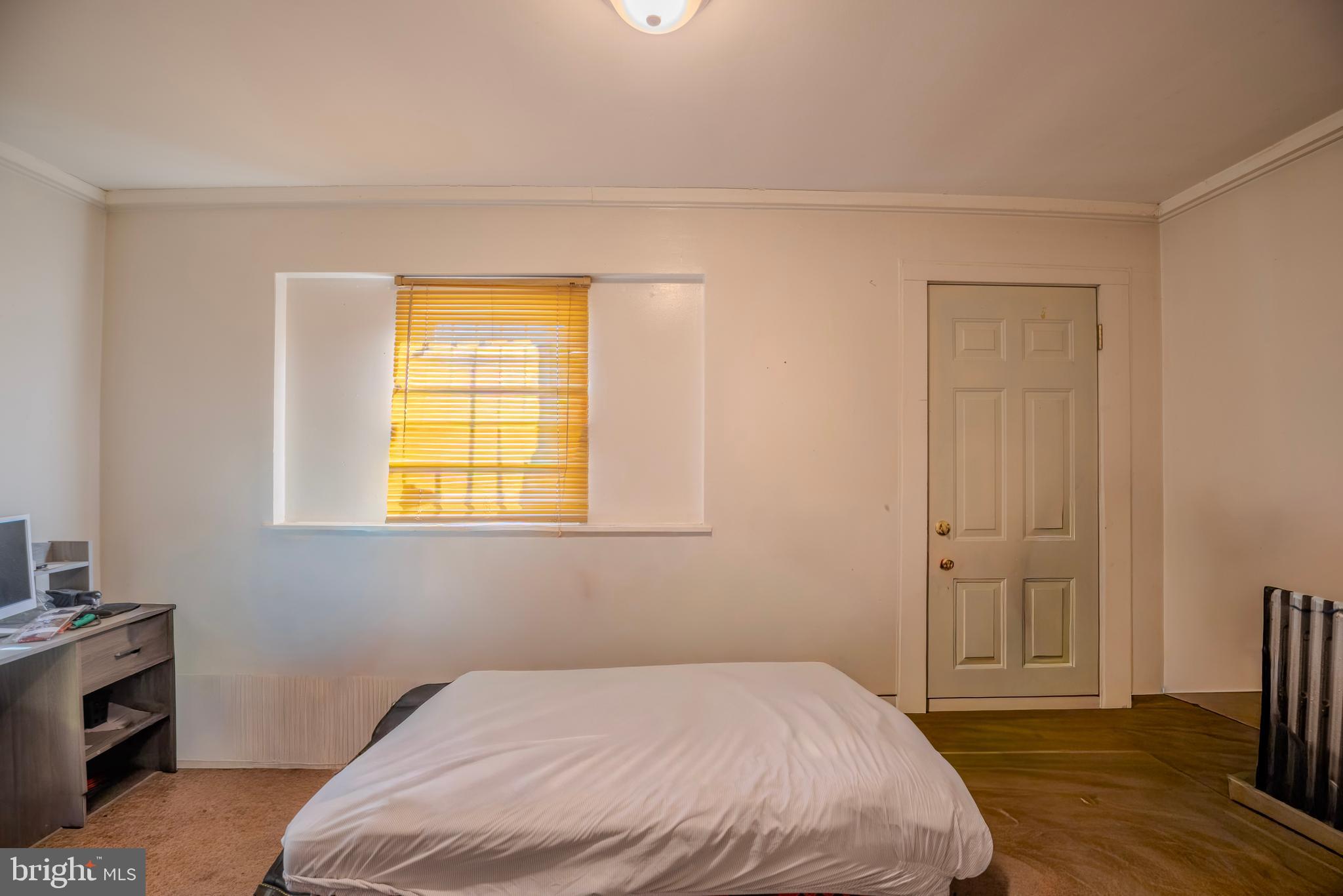 323 West 7th Street Chester, PA 19013 - Photo 13 of 39 a bedroom with a bed and wooden floor