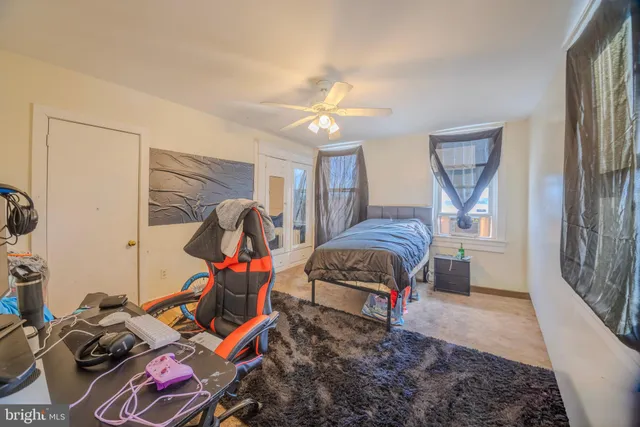 a living room with furniture a flat screen tv and a window