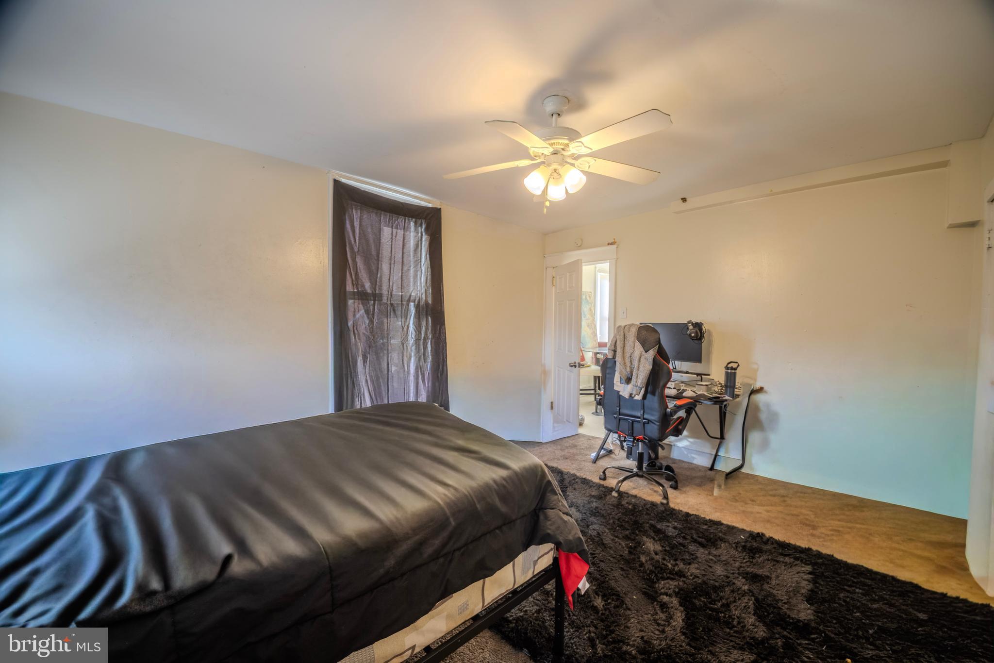 323 West 7th Street Chester, PA 19013 - Photo 16 of 39 a bedroom with a bed and a chandelier