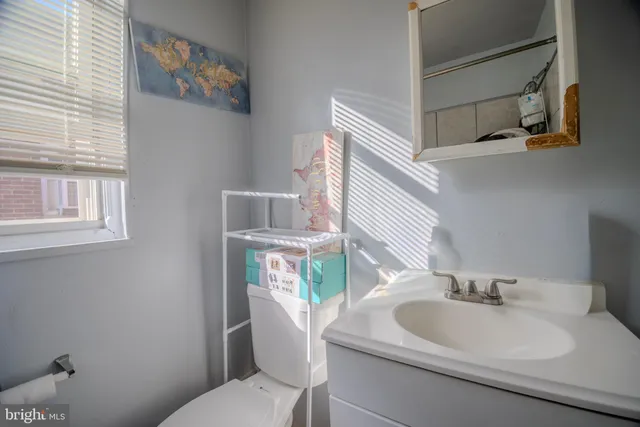 a bathroom with a sink a toilet and a mirror