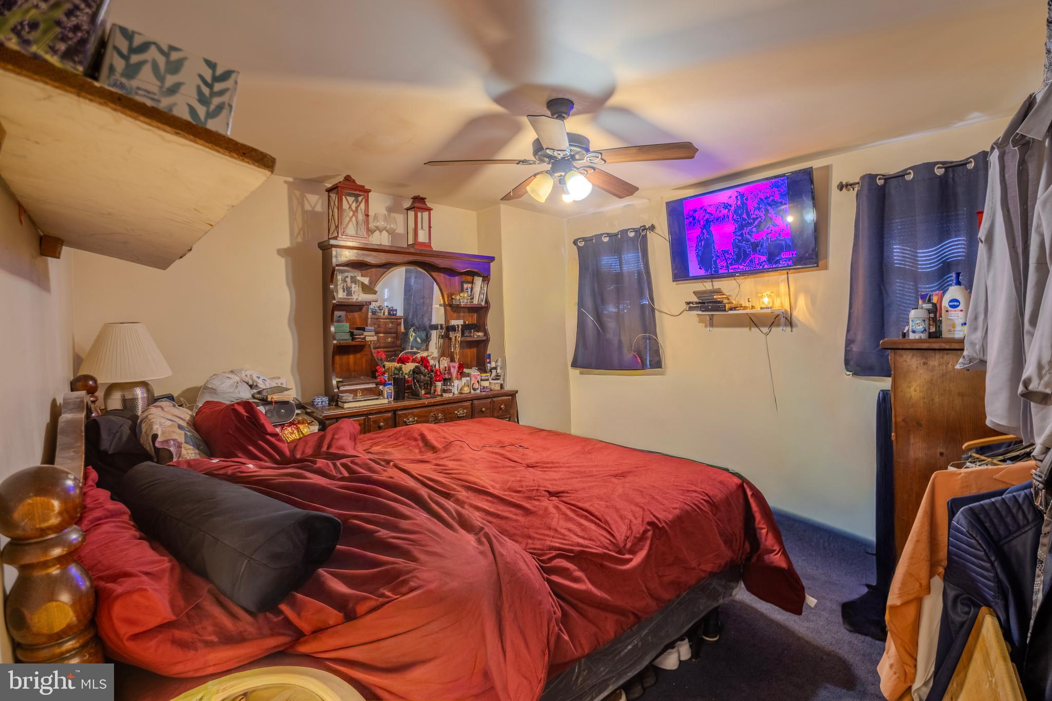 323 West 7th Street Chester, PA 19013 - Photo 30 of 39 a bedroom with a bed and a chandelier