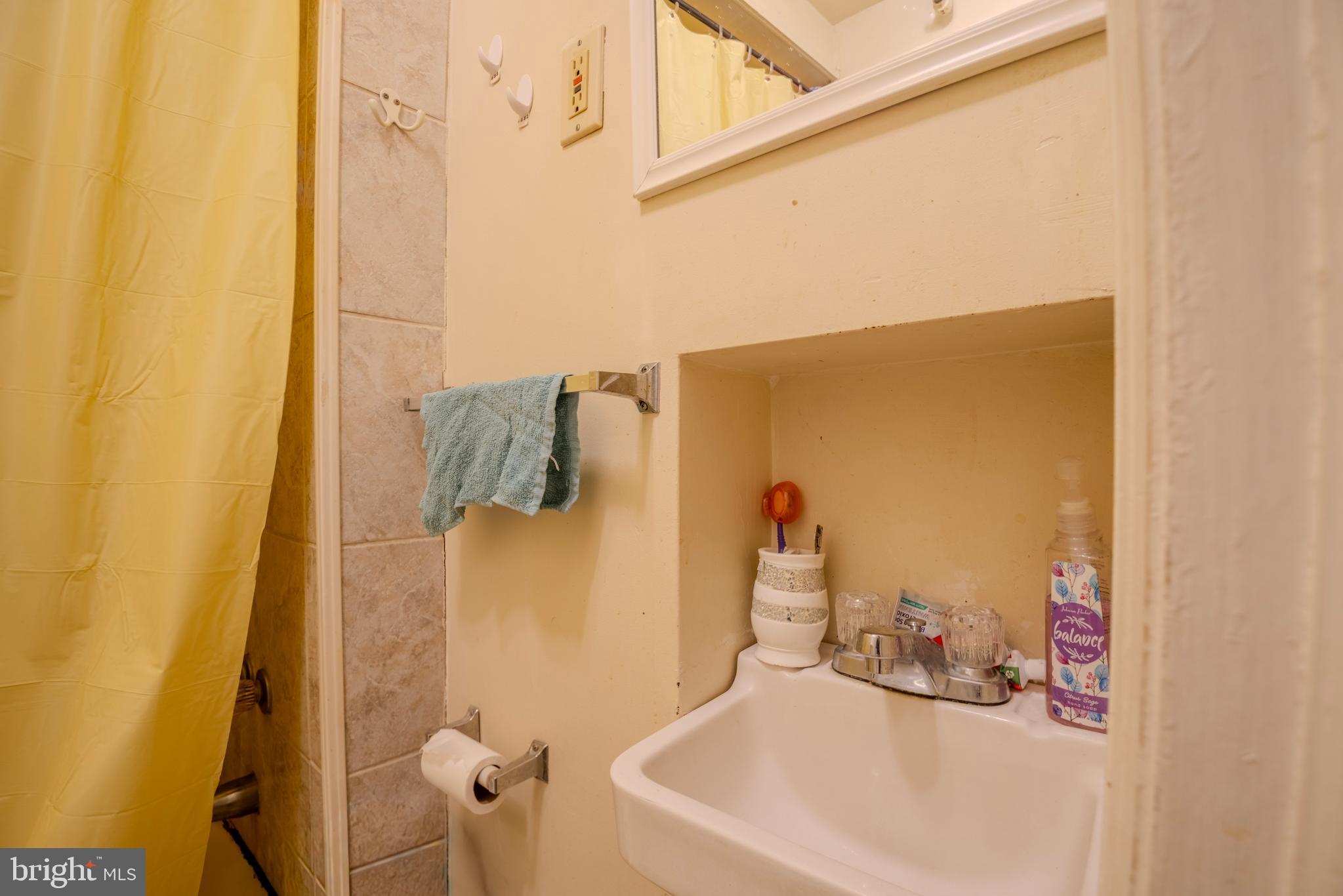 323 West 7th Street Chester, PA 19013 - Photo 31 of 39 a bathroom with a sink and mirror