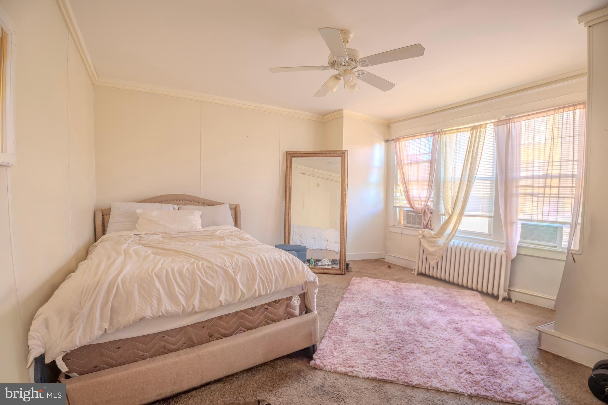 323 West 7th Street Chester, PA 19013 - Photo 33 of 39 a bedroom with a bed and a large window